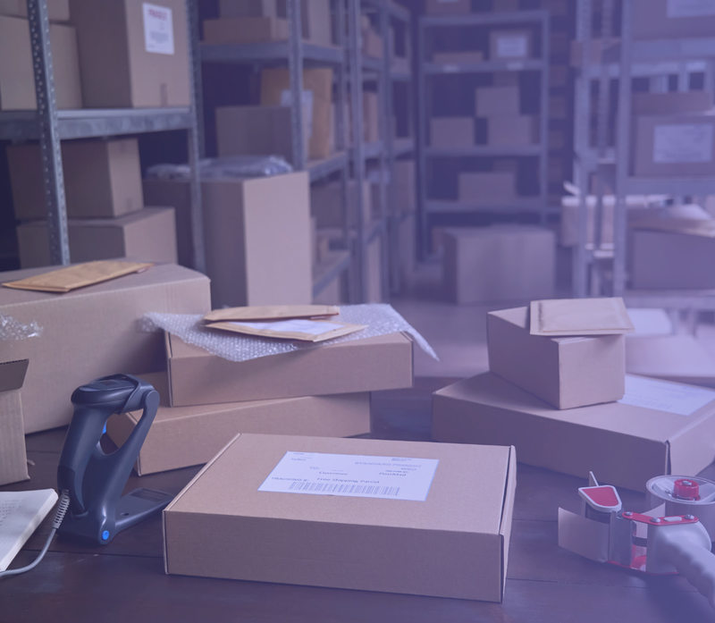 Parcels and a barcode scanner at a fulfillment packing station